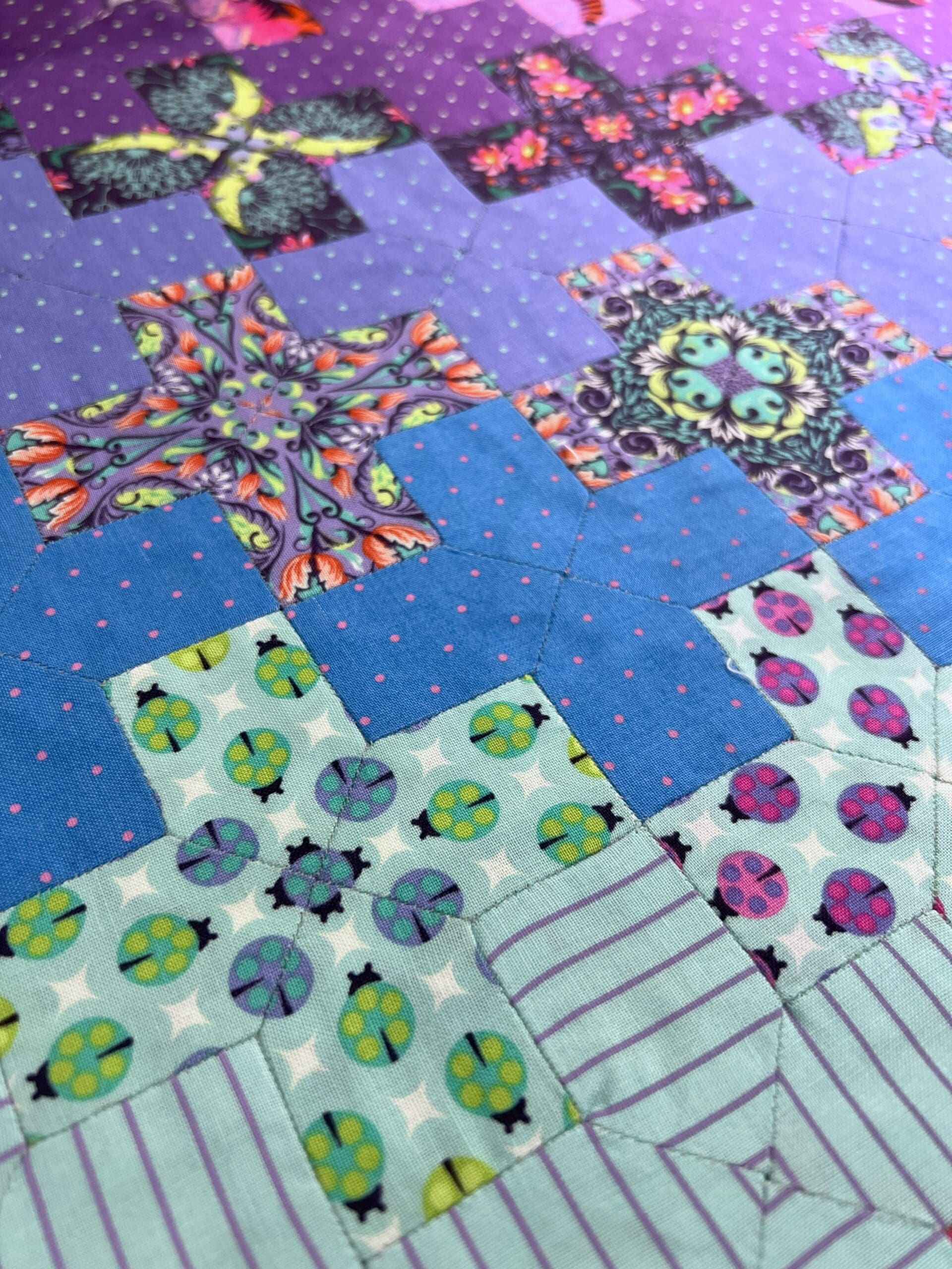A quilt with different designs on it.