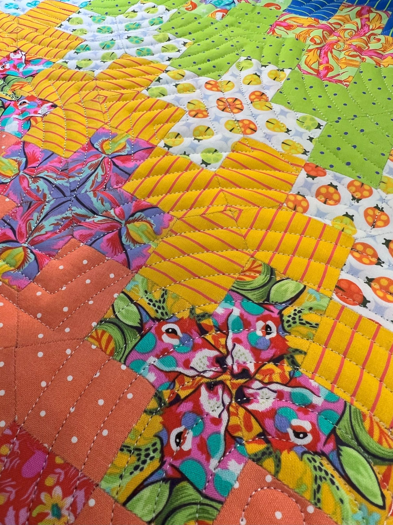 A close up of the colorful quilt