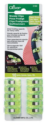 A package of green plastic clips for hanging clothes.