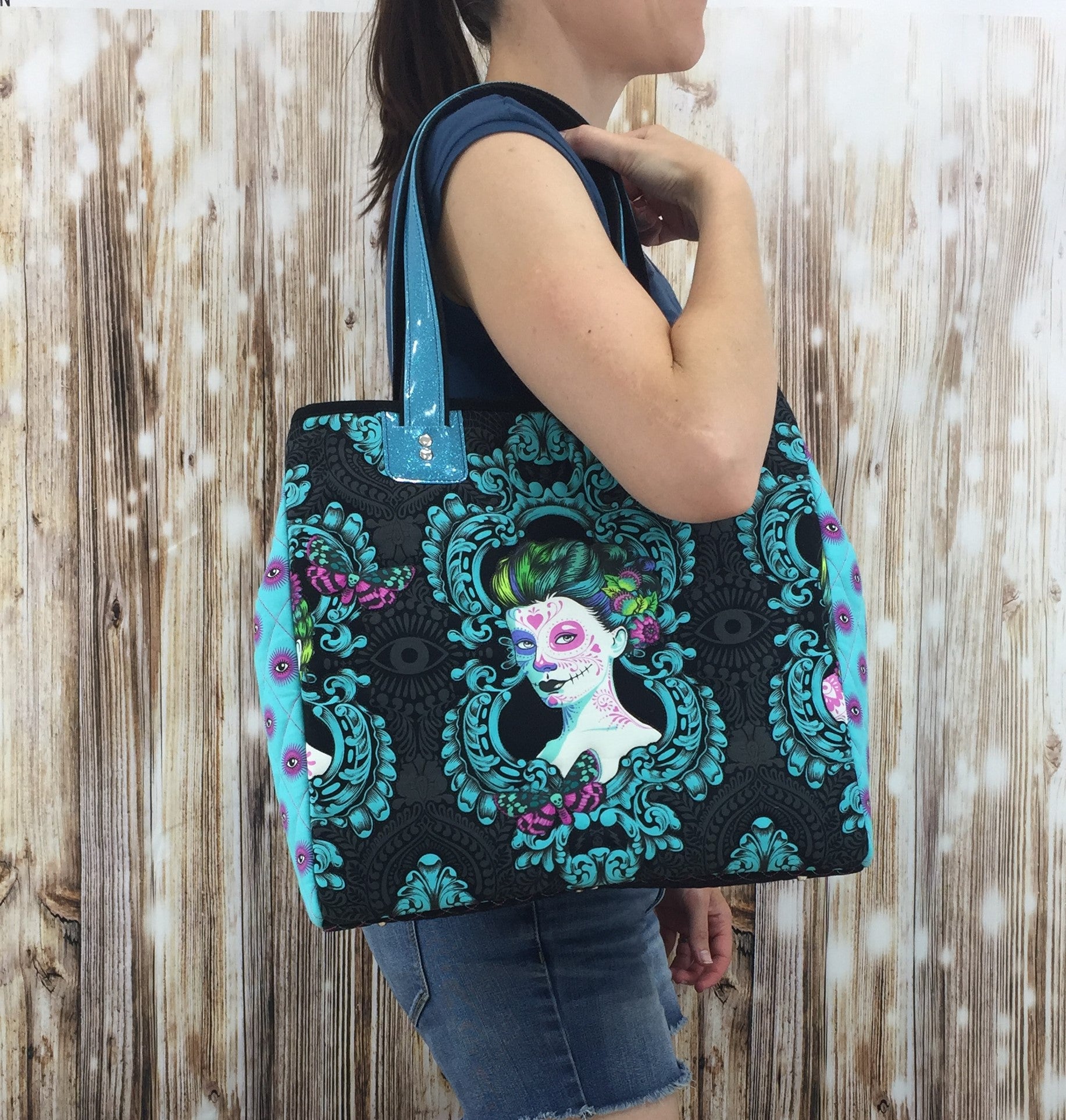 A woman is holding onto a bag with a picture of a girl.
