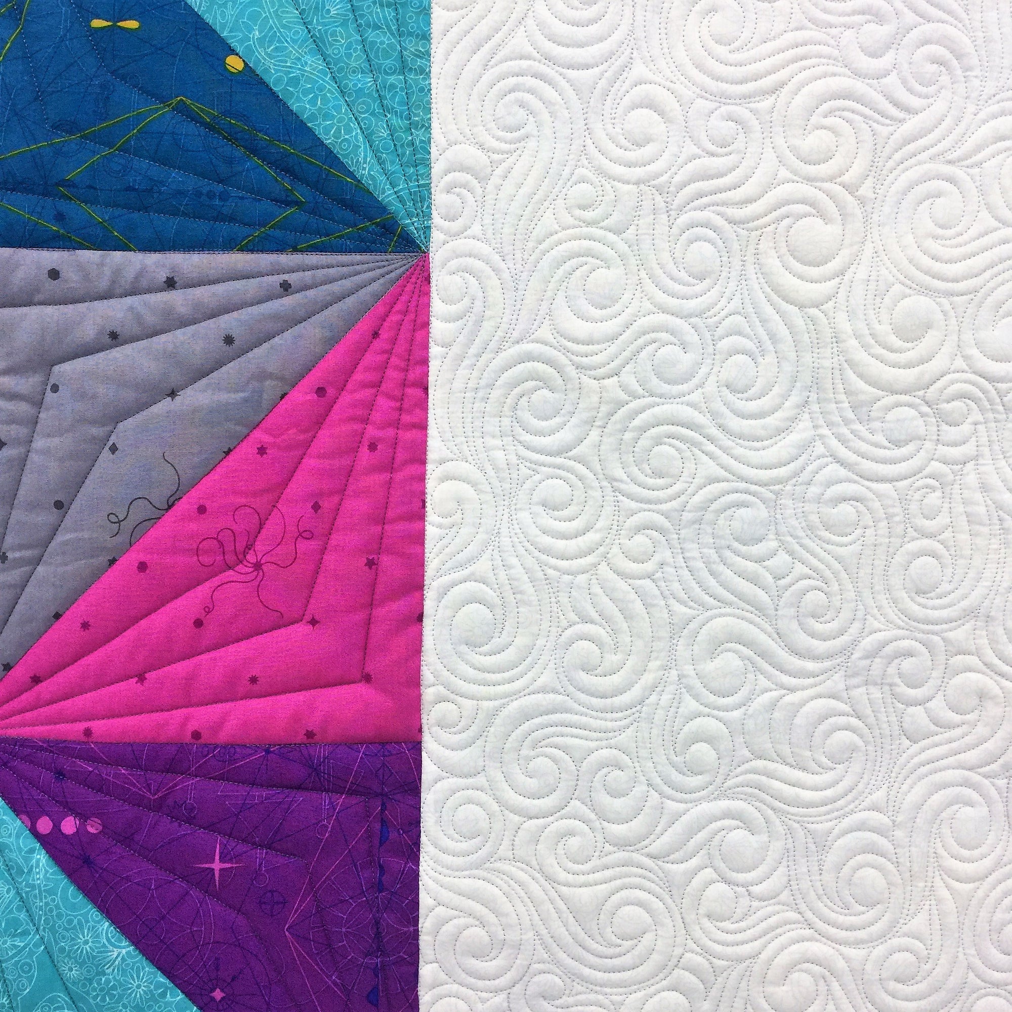 A close up of the quilt with white background