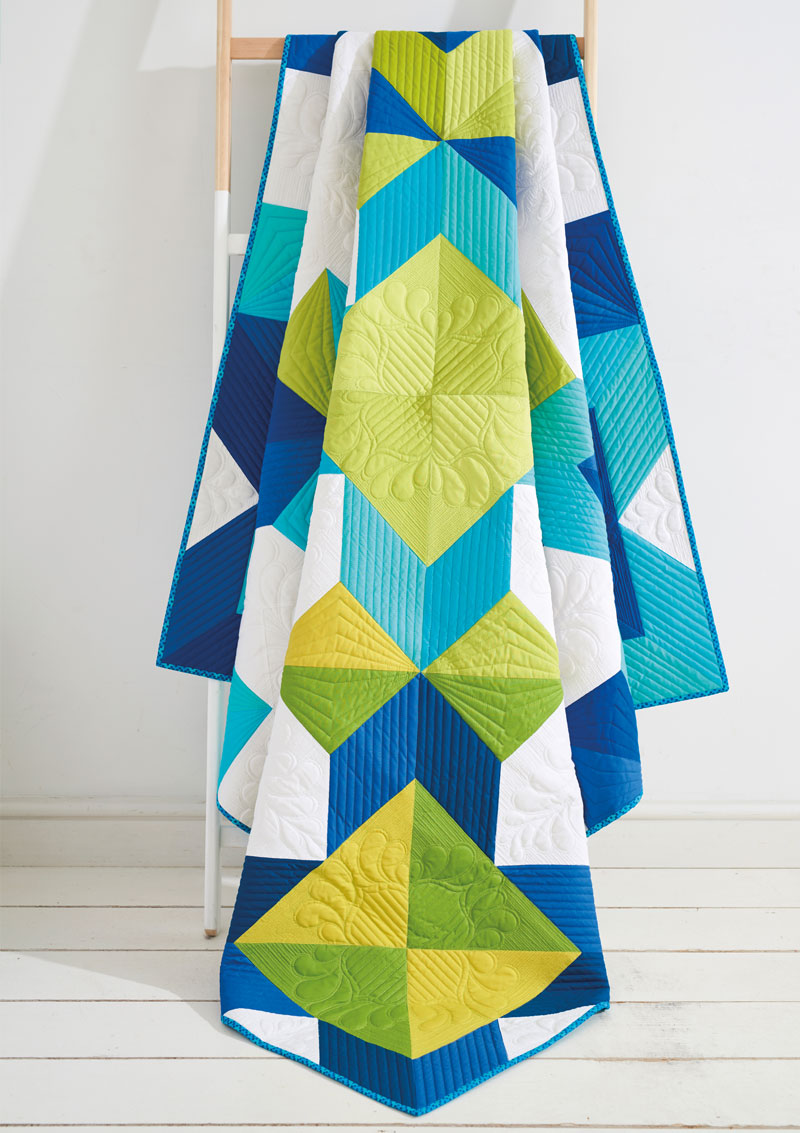 A quilt that is made of blue and green squares.