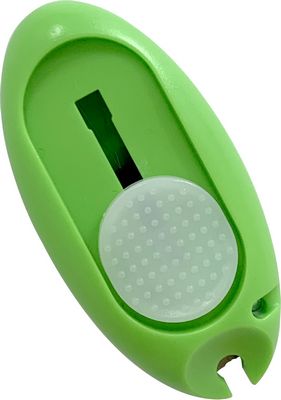 A green plastic case with a white button.