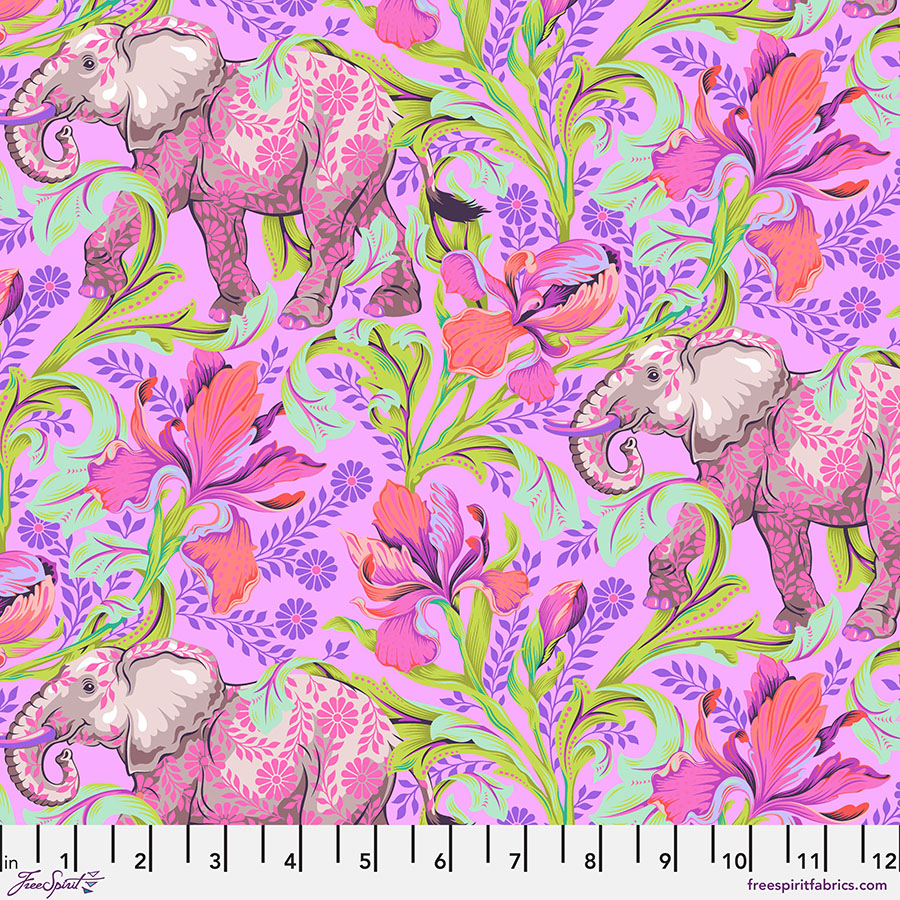 A pink elephant with flowers on it's back.