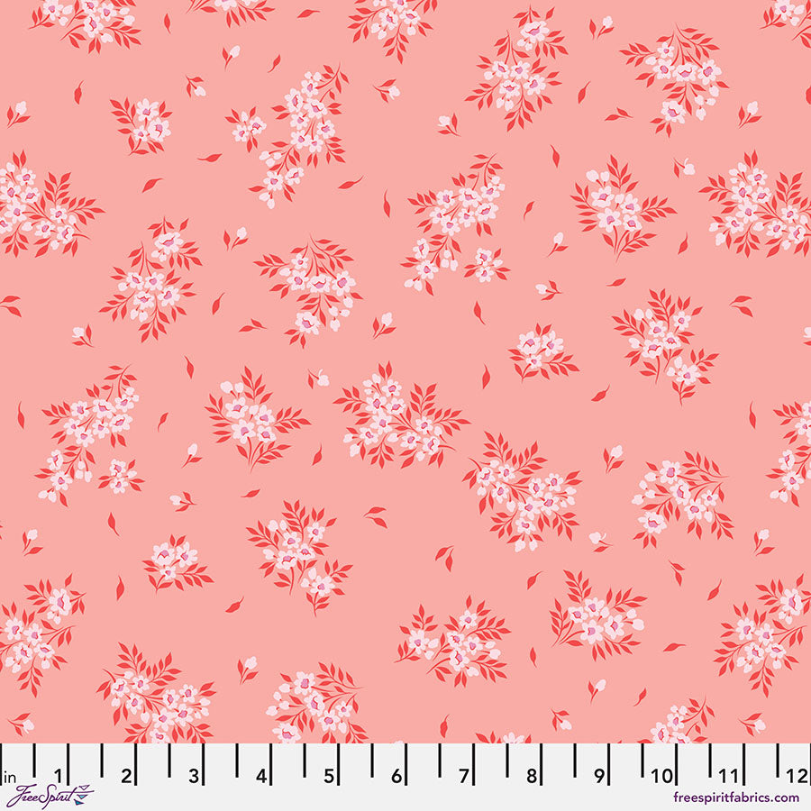 Pink fabric with small floral prints and white measuring tape.