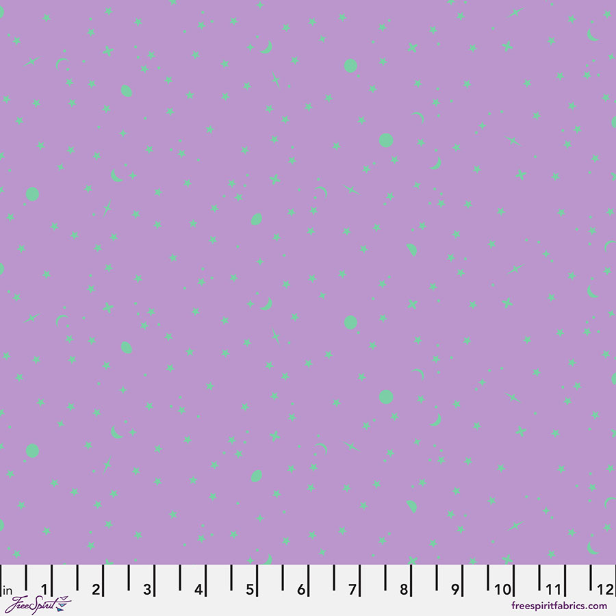 Purple fabric with small blue and green dots and a white ruler at the bottom.