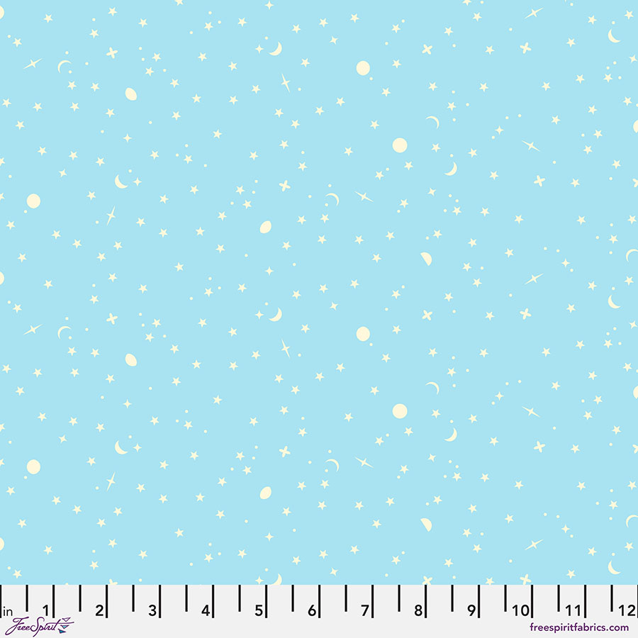 Light blue fabric with white snowflake pattern and ruler for scale.