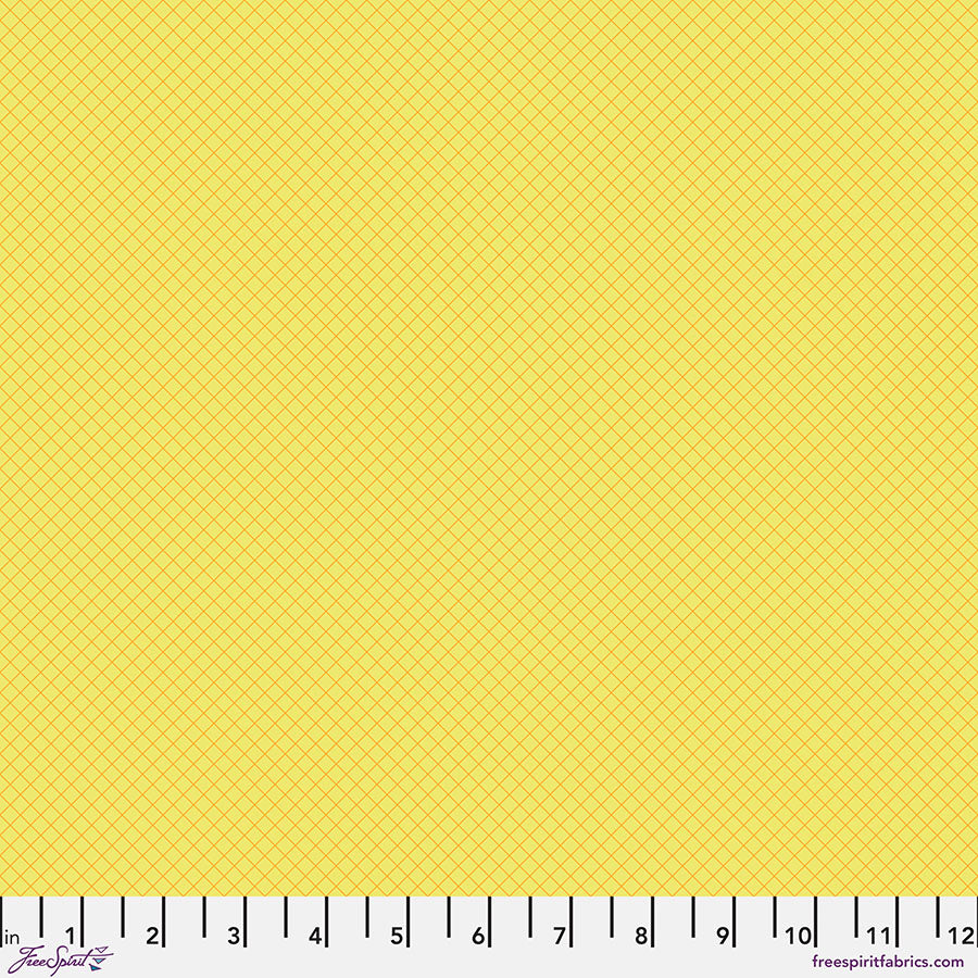 Solid yellow fabric swatch with ruler for scale.