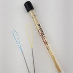 A pair of needles and a wooden stick