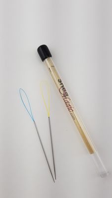 A pair of needles and a wooden stick