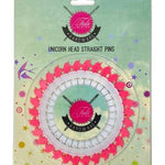 A pink and white circular pin with the words " unicorn head straight pins ".