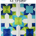 A quilt that is made of blue and green squares.