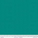 A green fabric with white dots on it