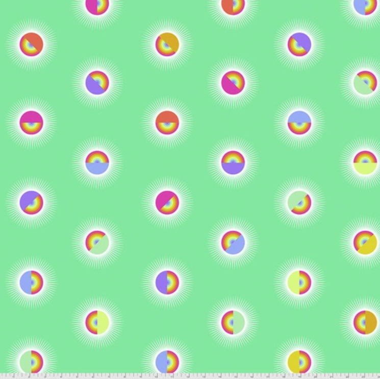 A green background with colorful circles in the middle.