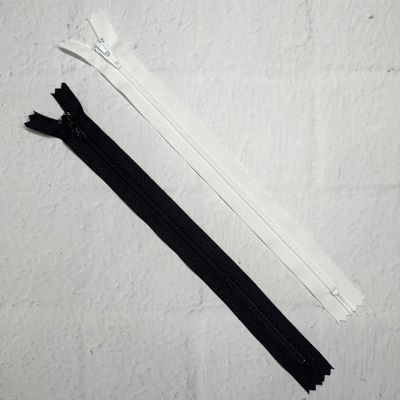 A pair of zippers are laying on the floor.