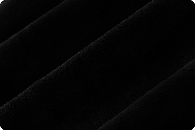 Close-up of soft black fabric with smooth texture.