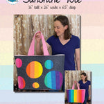 A woman holding onto a large bag with circles on it