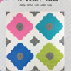 A quilt with four different colored flowers on it.
