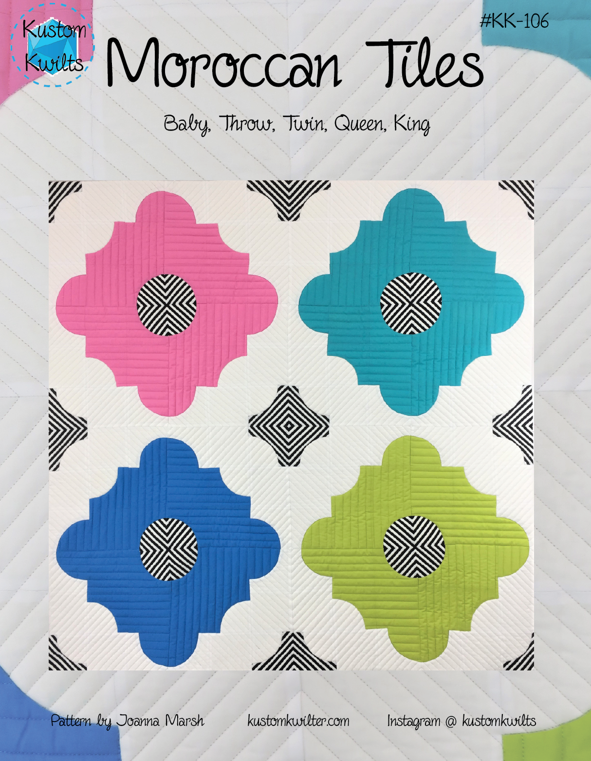 A quilt with four different colored flowers on it.