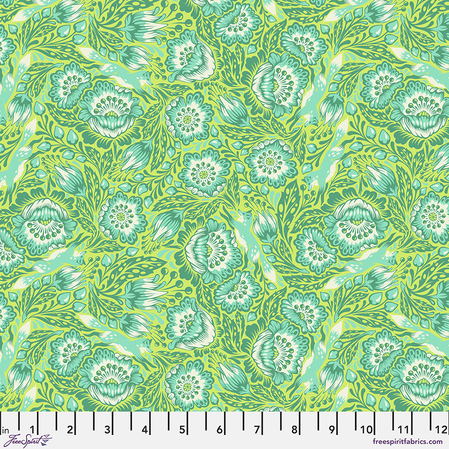 A green floral pattern is shown on fabric.