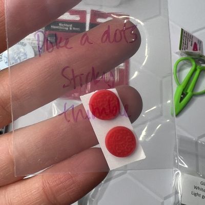 Two red pills held on a small strip in a plastic bag.