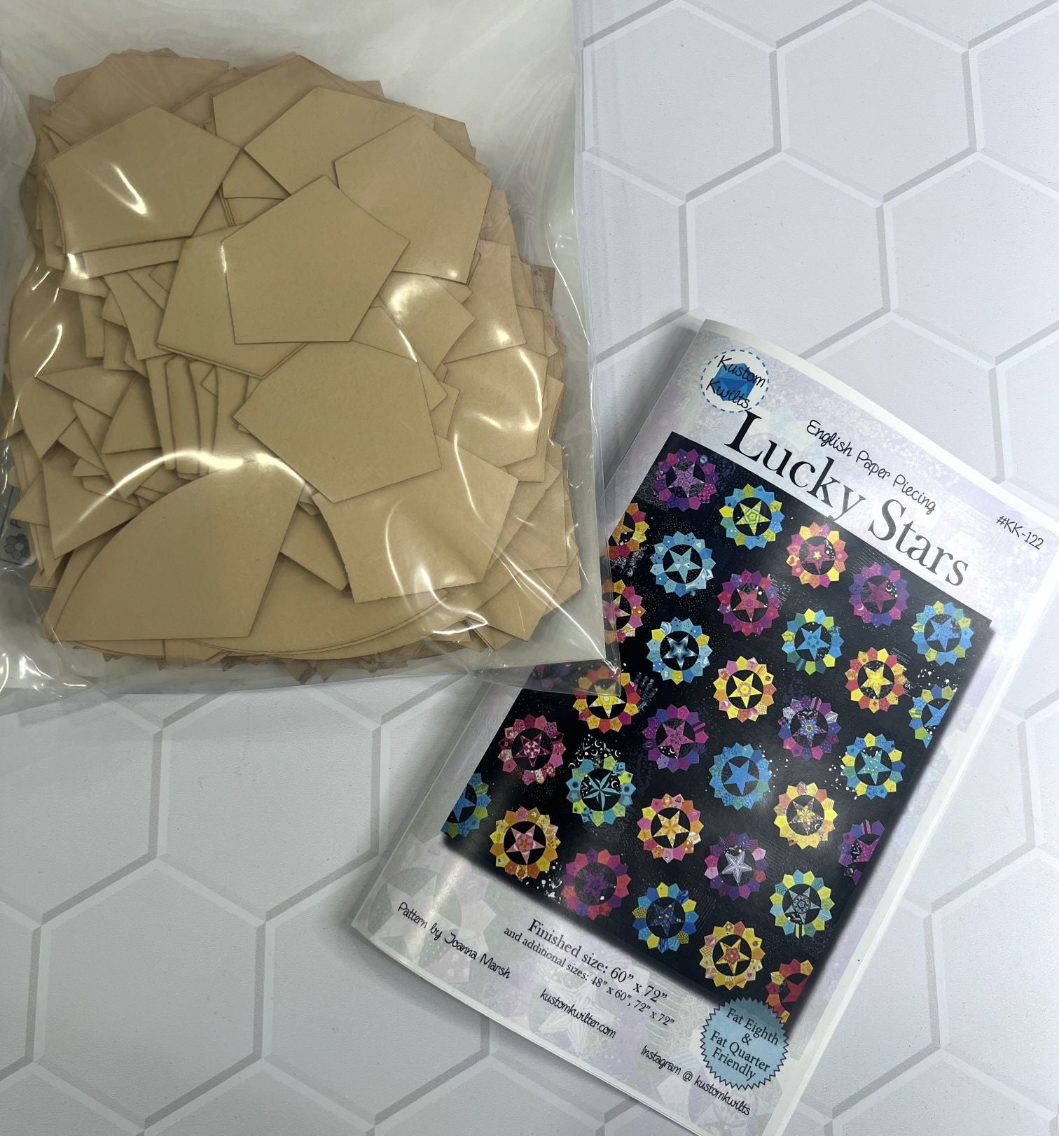Package of beige modeling clay and a sheet of colorful smiley face stickers.