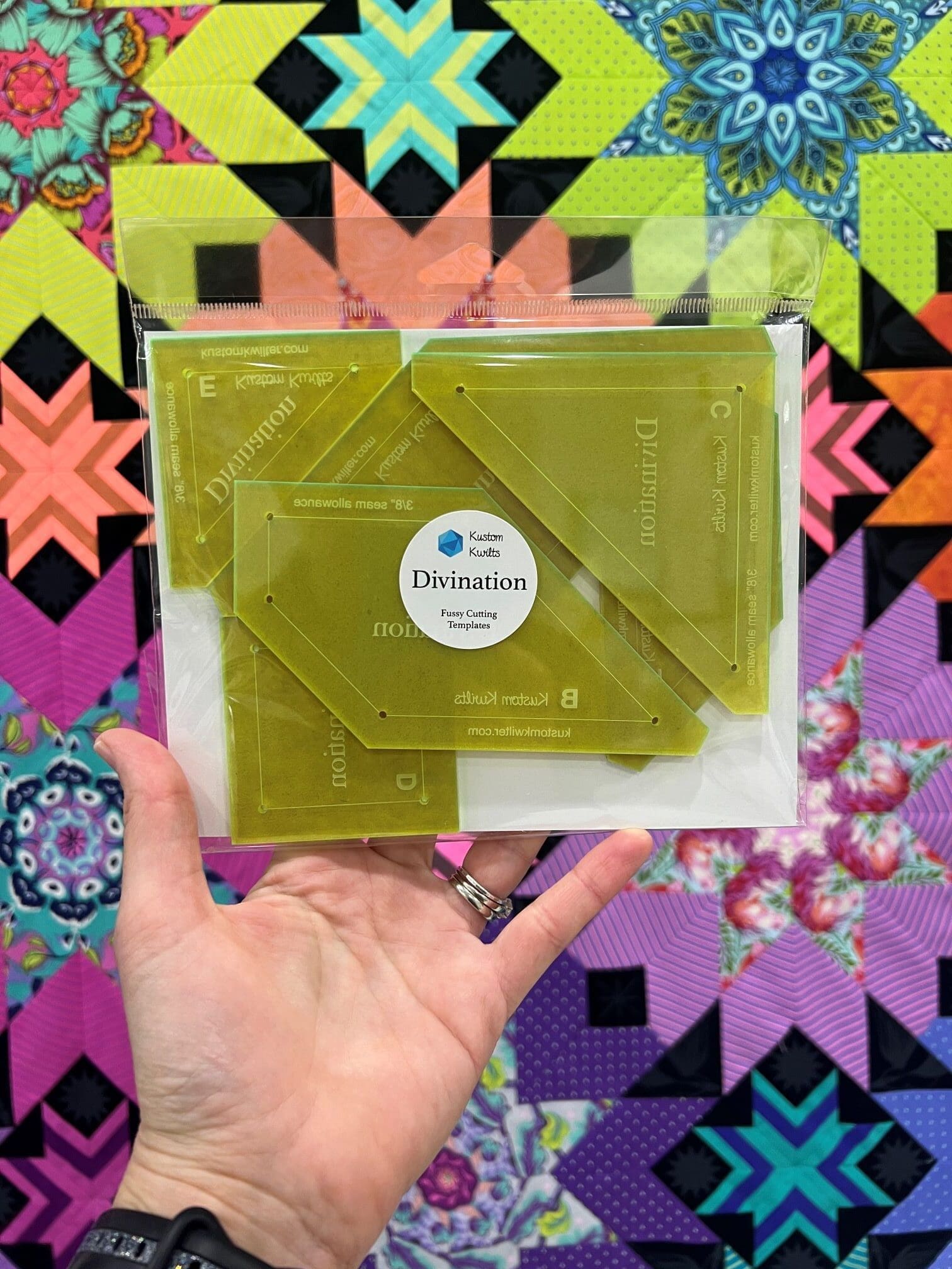 A person holding up a package of plastic templates.