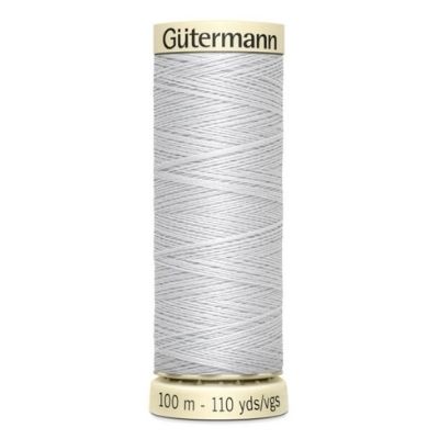 A spool of thread with white thread on it.