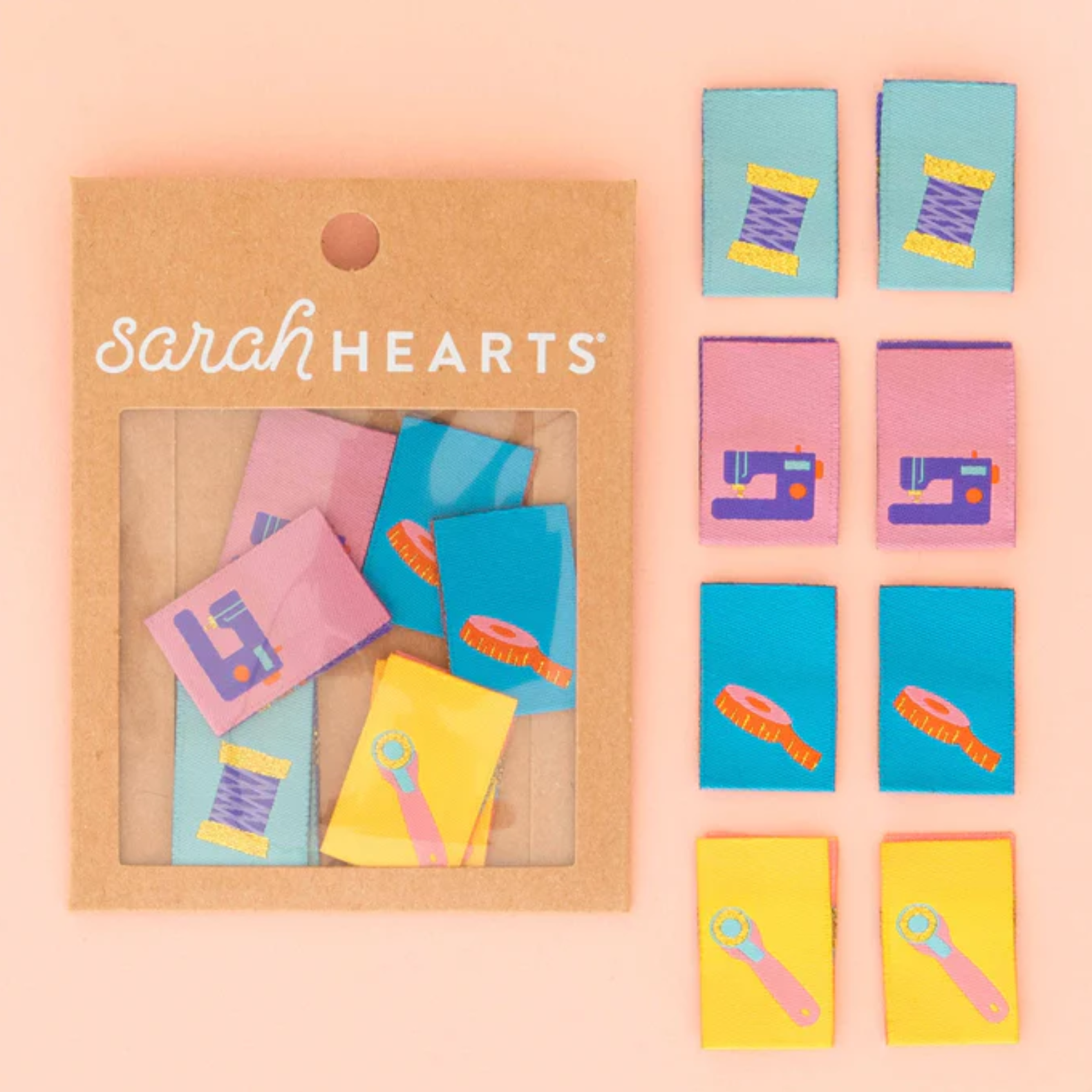 Colorful miniature notebooks and pencils arranged on a peach background.