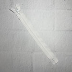 A white piece of fabric with two zippers.
