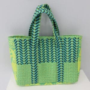 Green and blue patterned fabric tote bag.