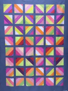Colorful patchwork quilt with geometric patterns.