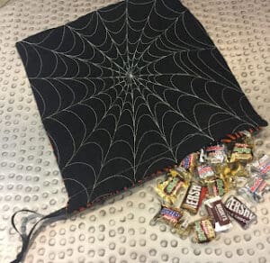 Spiderweb bag with assorted candies spilling out.