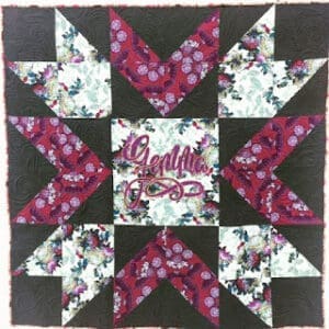 Floral quilt block with geometric patterns.