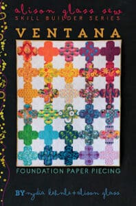 Colorful quilt pattern with geometric shapes.
