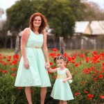 A woman and child in the middle of a field.