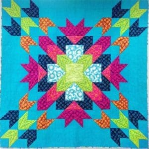 A quilt with colorful designs on it.