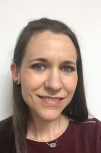 A woman with long hair and blue eyes.