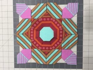 A quilt with different colored designs on it.