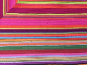 A colorful background of many strips of paper.