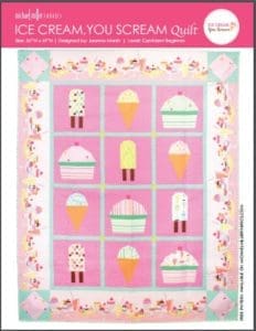 A quilt with ice cream and cupcakes on it.