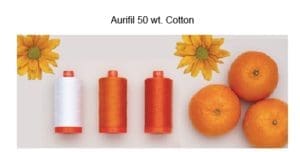 A group of orange and white thread next to each other.