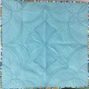 A blue quilt with a design on it.