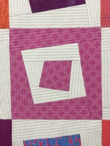 A close up of the square quilt pattern
