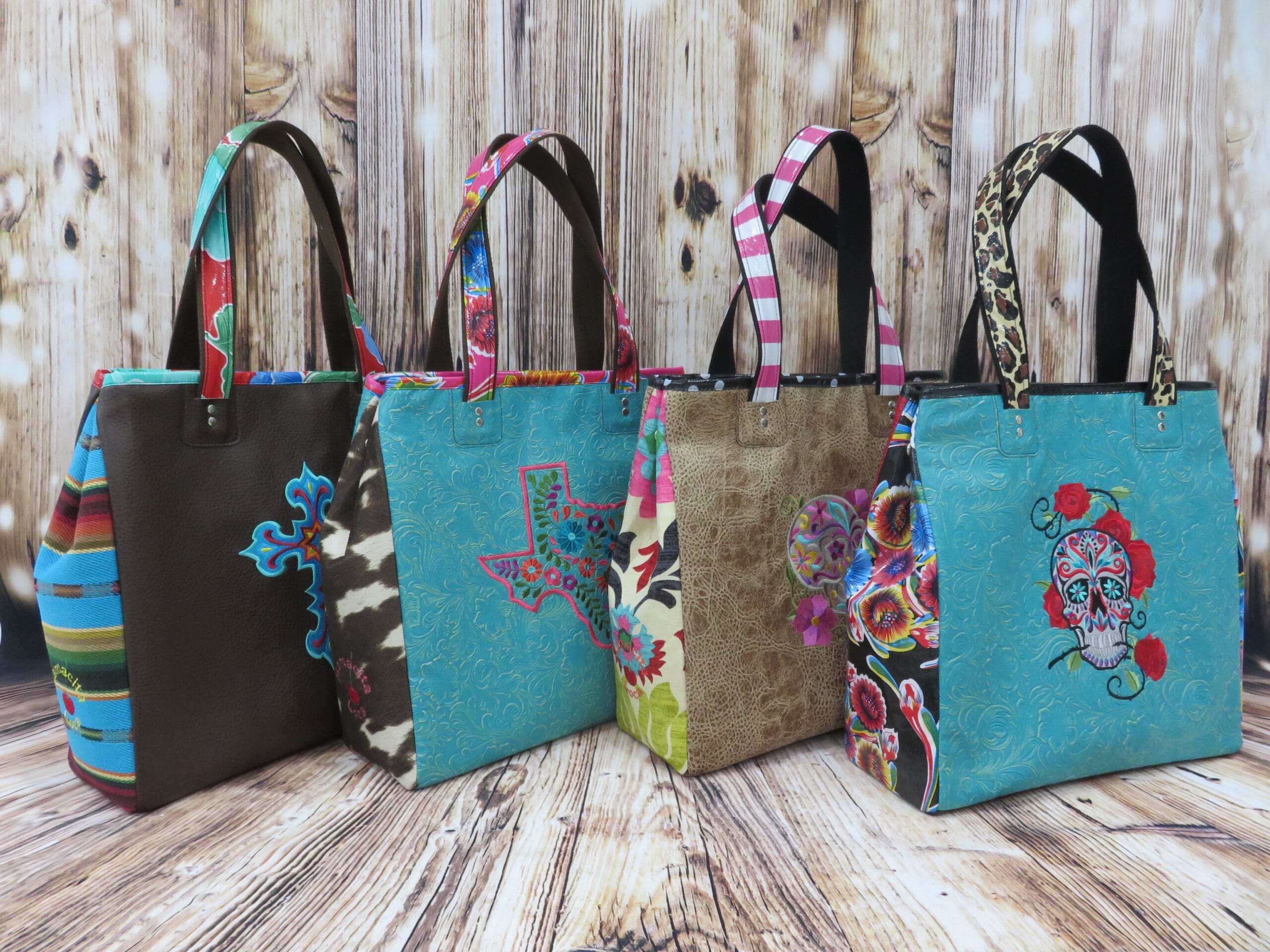 A group of four bags sitting on top of a wooden floor.