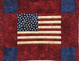 A red, white and blue flag quilt with the american flag on it.