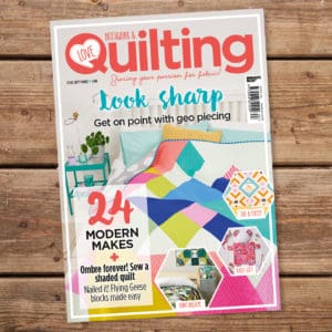 A magazine cover with a quilt on it.