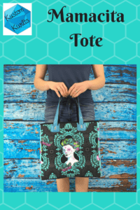 A woman holding onto a black bag with a picture of a woman on it.