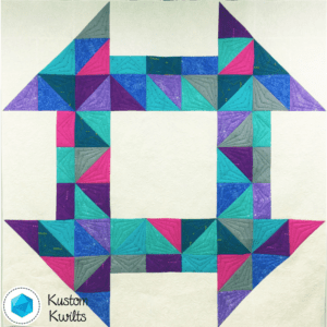 A quilt with different colored squares and triangles.