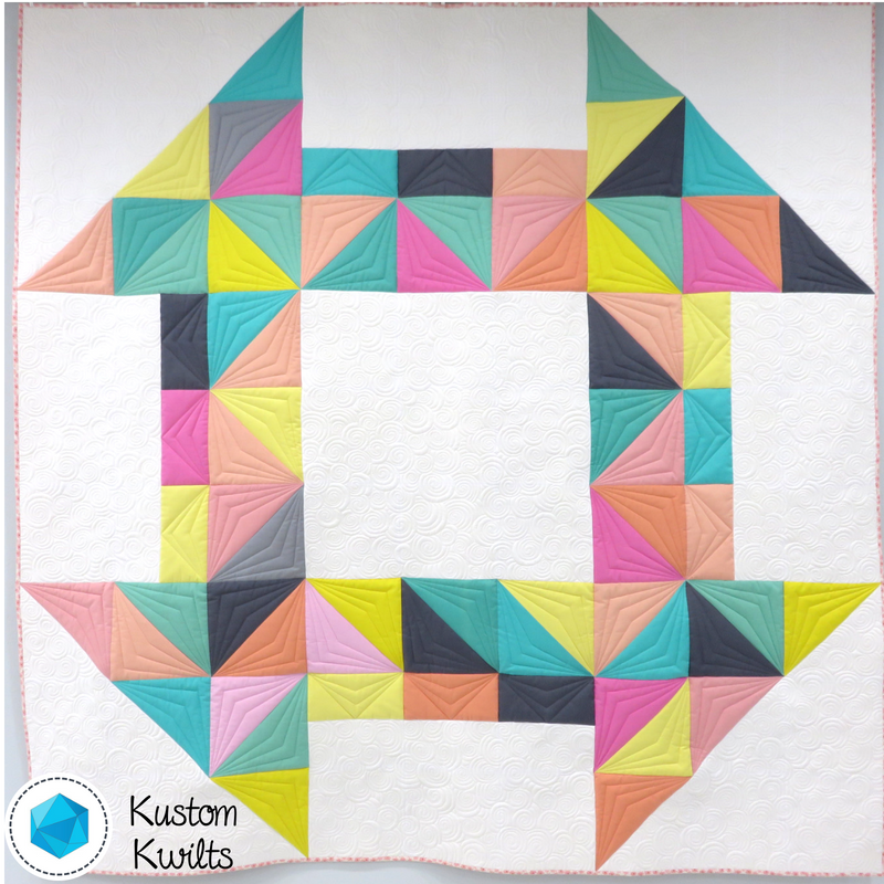 A quilt with different colored triangles on it.